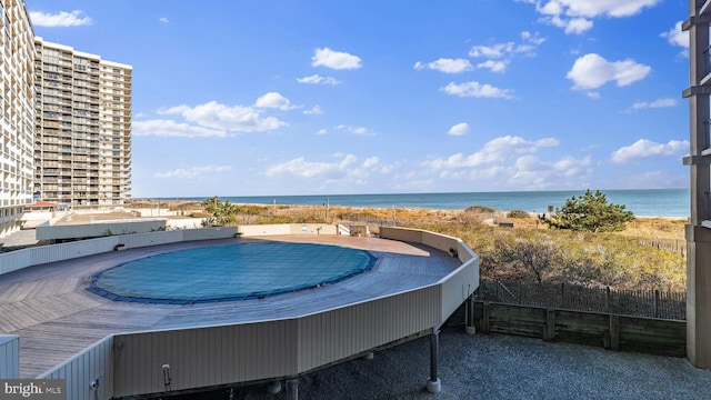 view of swimming pool featuring a water view