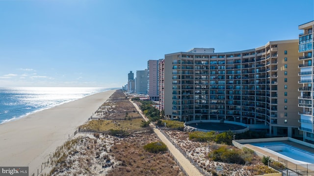 exterior space featuring a water view and a beach view