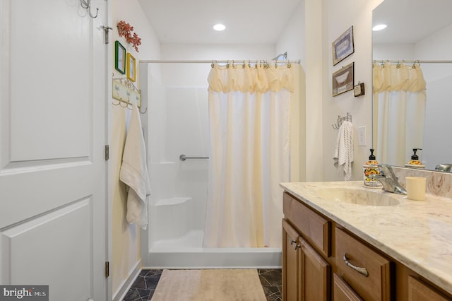 bathroom featuring tile patterned floors, vanity, and walk in shower