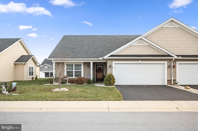 view of front of home featuring a front lawn and a garage