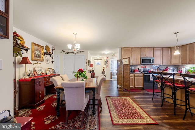 dining area featuring dark hardwood / wood-style flooring and a chandelier