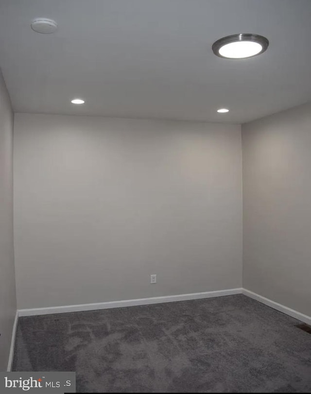 empty room with dark colored carpet