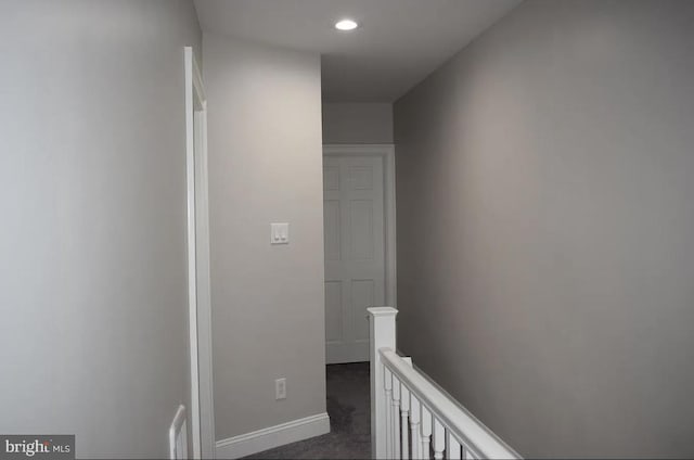 hallway with dark carpet