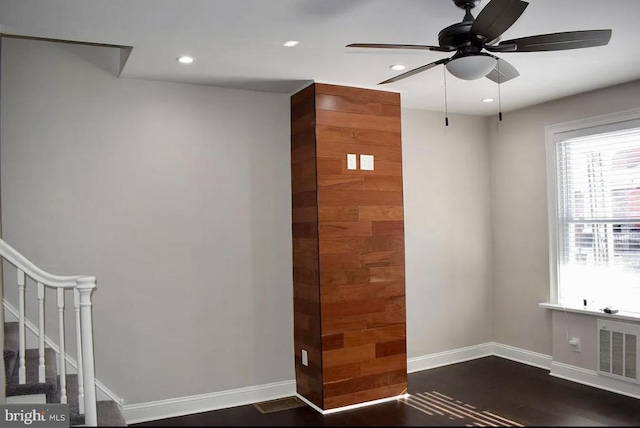 spare room featuring ceiling fan and dark hardwood / wood-style flooring