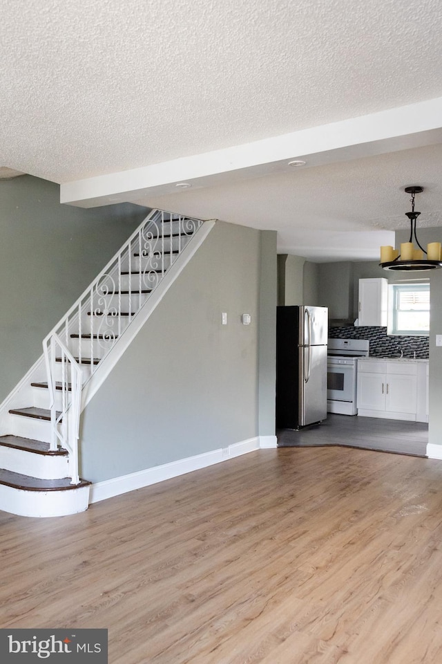 interior space featuring hardwood / wood-style flooring and a textured ceiling