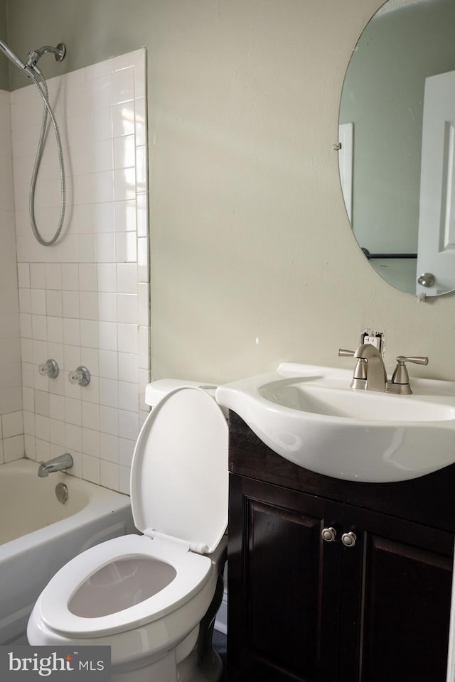 full bathroom featuring vanity, toilet, and tiled shower / bath