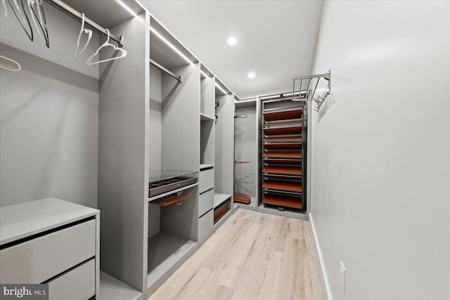 spacious closet featuring light hardwood / wood-style flooring