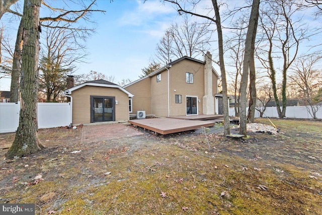 rear view of property with a wooden deck