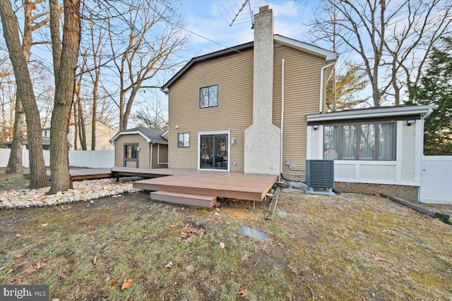 back of house featuring cooling unit and a deck