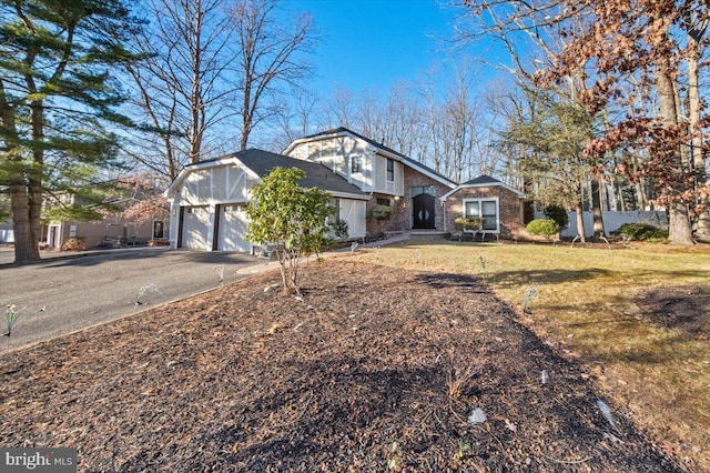 view of front of house with a garage and a front yard