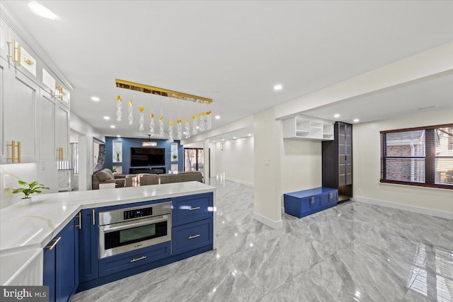 kitchen featuring white cabinets, stainless steel oven, and blue cabinetry