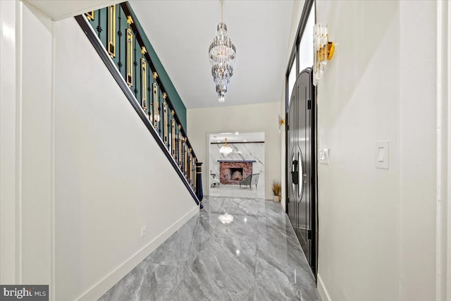 foyer with a chandelier and a fireplace