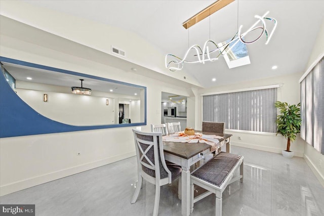 dining area with lofted ceiling with skylight