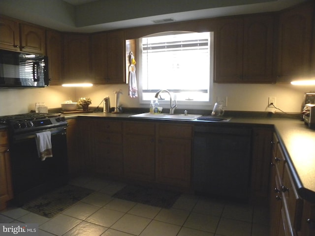 kitchen with black appliances, light tile patterned floors, and sink