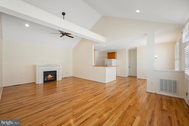 unfurnished living room featuring ceiling fan, light hardwood / wood-style floors, and lofted ceiling