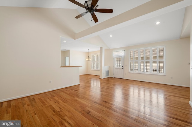 unfurnished living room with light wood-type flooring, lofted ceiling with beams, and ceiling fan with notable chandelier