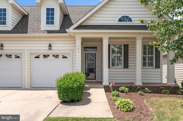 view of front of house featuring a porch and a garage