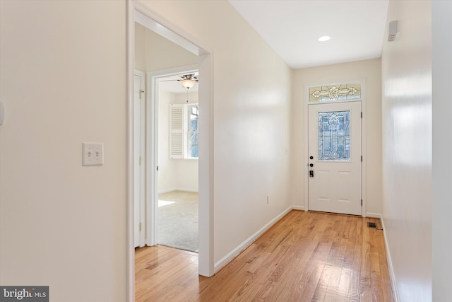 entryway featuring ceiling fan, a healthy amount of sunlight, and light wood-type flooring