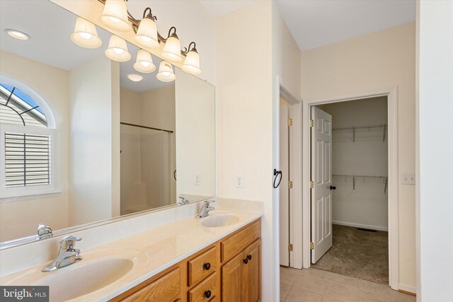 bathroom featuring a shower, vanity, and tile patterned floors