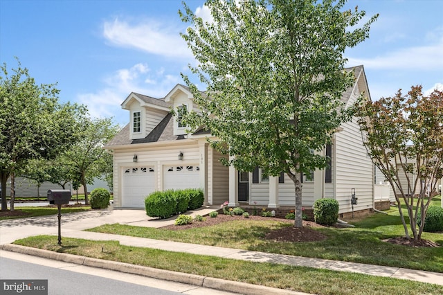 view of front of property with a garage and a front lawn