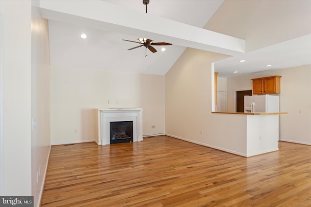 101 Forget Me Not Dr, White Post, VA 22663 - unfurnished living room featuring ceiling fan, light wood finished floors, recessed lighting, lofted ceiling, and a glass covered fireplace