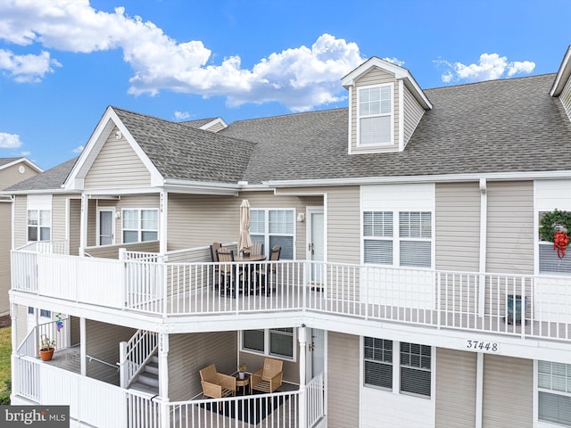 rear view of property with an outdoor living space