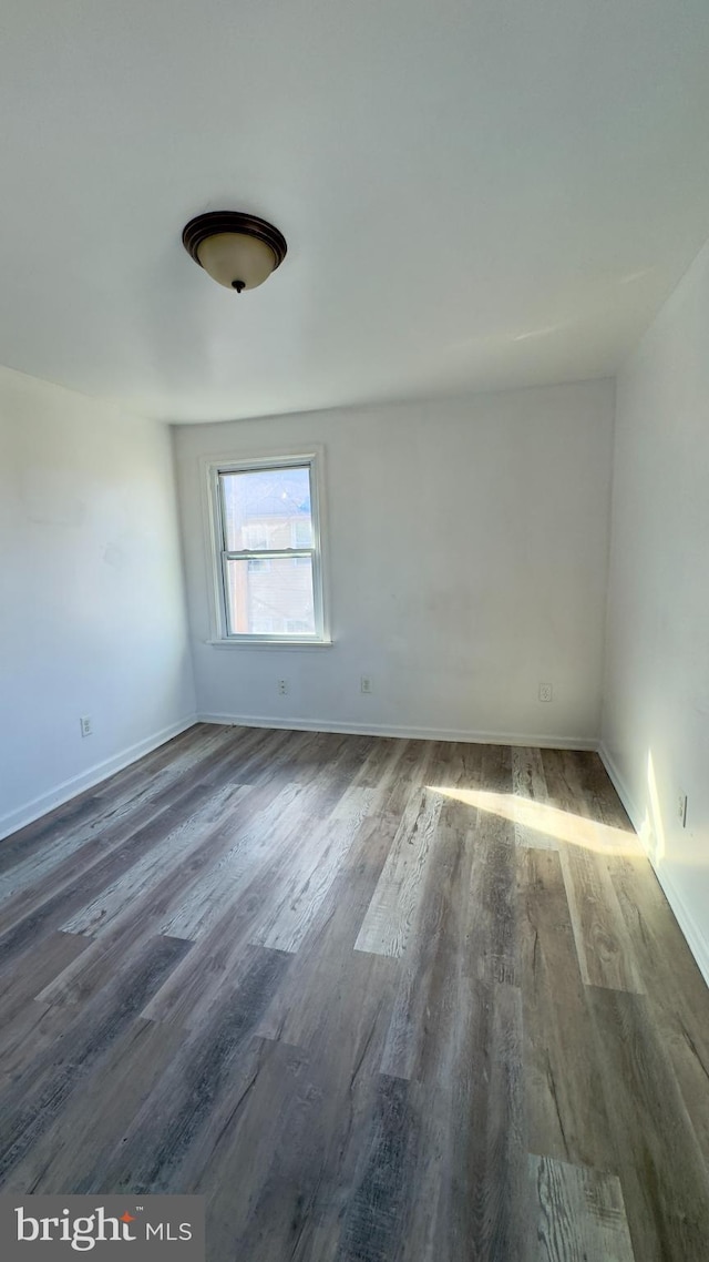 empty room with dark hardwood / wood-style floors