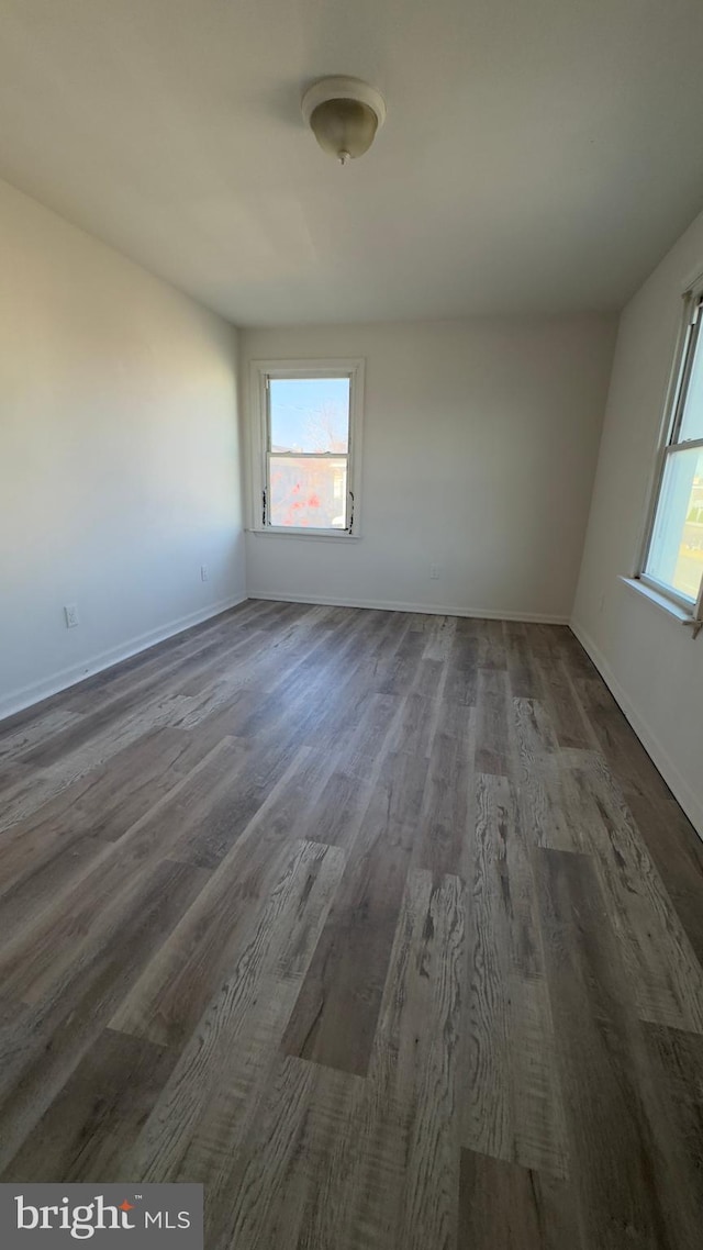 spare room with dark wood-type flooring