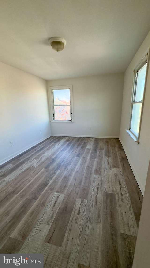 spare room with dark hardwood / wood-style floors