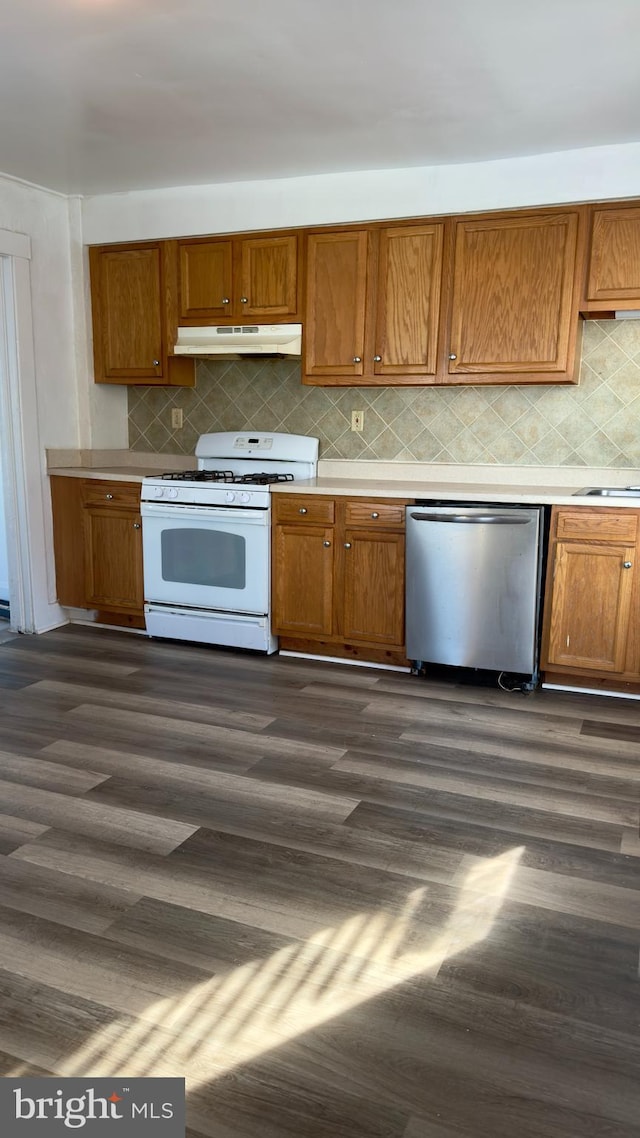 kitchen with backsplash, dishwasher, white gas stove, and dark hardwood / wood-style floors