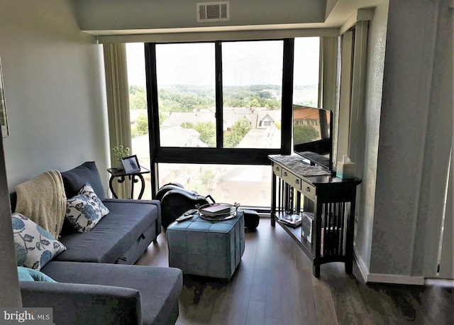 living room featuring visible vents and wood finished floors