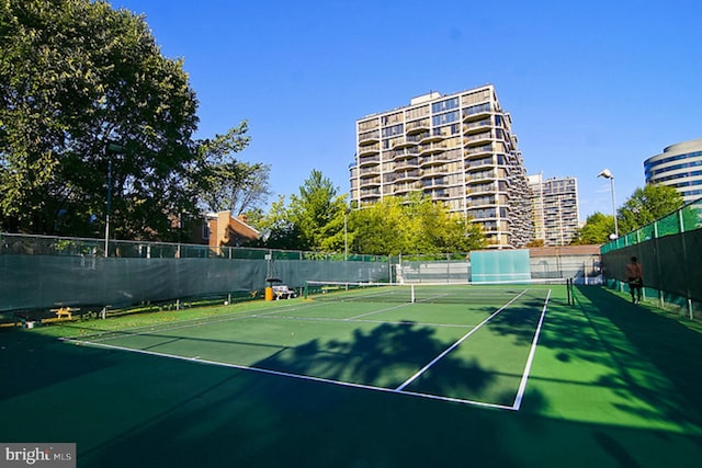 view of tennis court with fence