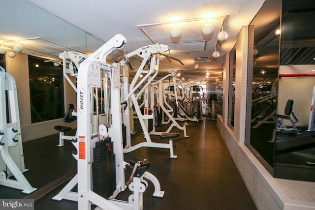 gym featuring rail lighting