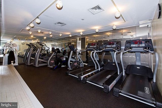 workout area featuring visible vents and track lighting