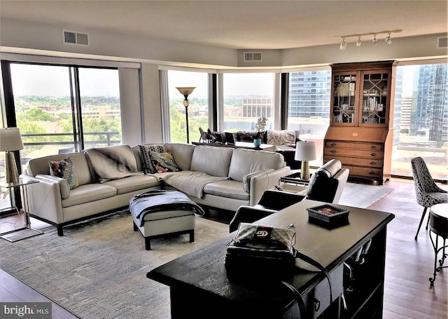 living room with visible vents and light wood-type flooring