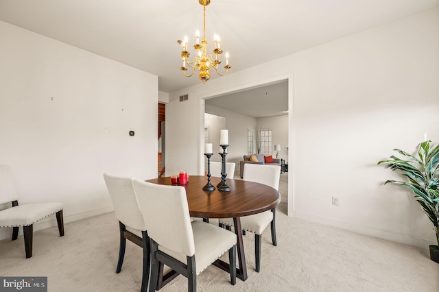 carpeted dining space with a notable chandelier