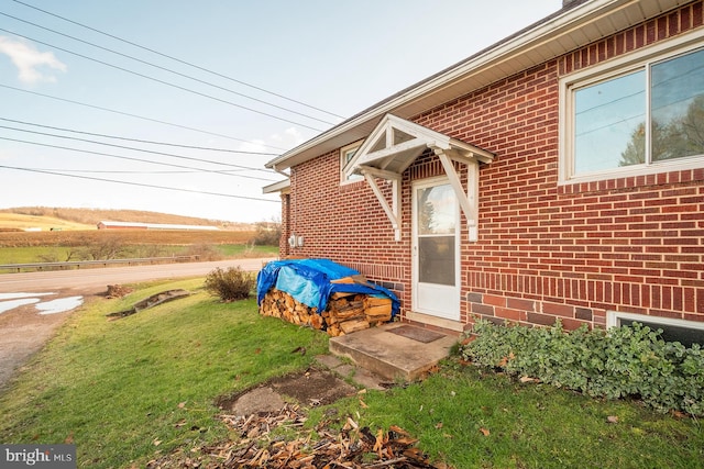 view of exterior entry with a lawn