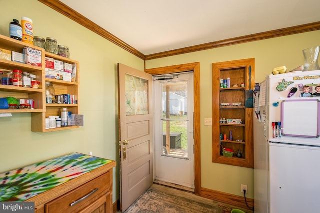 doorway with dark hardwood / wood-style floors and crown molding