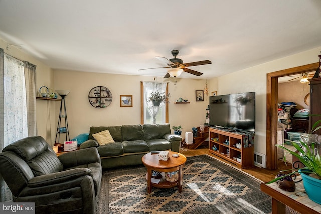 living room featuring ceiling fan and hardwood / wood-style flooring