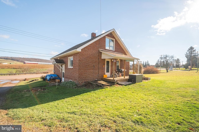 view of side of home featuring a lawn and central air condition unit