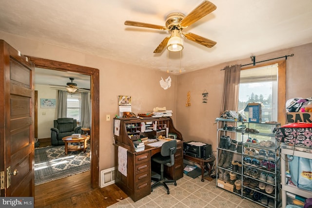 office with a wealth of natural light, ceiling fan, and light hardwood / wood-style floors