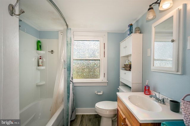 full bathroom with vanity, toilet, ornamental molding, wood-type flooring, and shower / tub combo