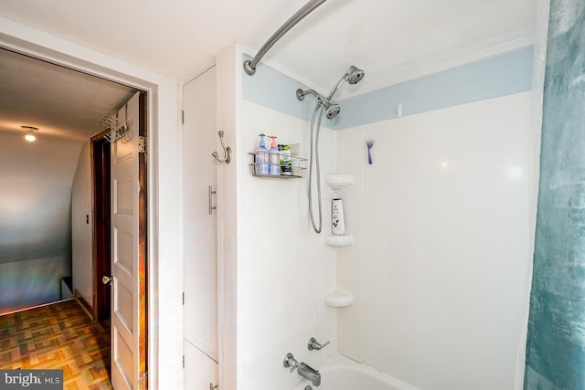 bathroom featuring parquet floors and shower / bathtub combination