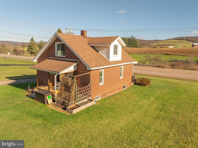 back of property featuring a yard