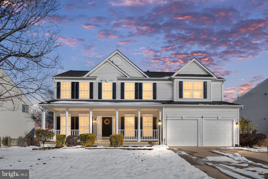 view of front facade with a garage and a porch