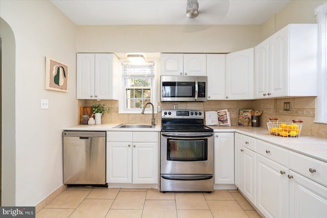 841 E Belvedere Ave E, Baltimore, MD 21212 - kitchen featuring stainless steel appliances, a sink, decorative backsplash, and white cabinets