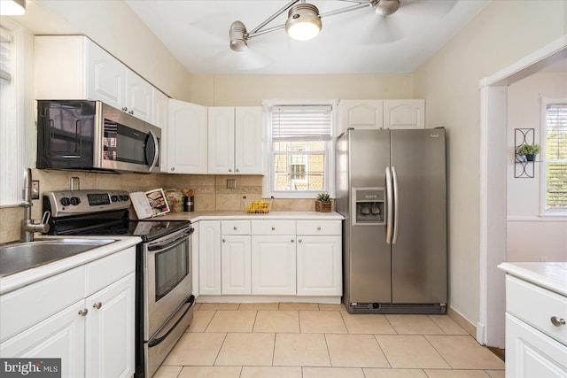 841 E Belvedere Ave E, Baltimore, MD 21212 - kitchen featuring appliances with stainless steel finishes, ceiling fan, and white cabinetry