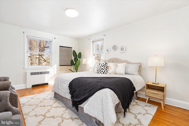 841 E Belvedere Ave E, Baltimore, MD 21212 - bedroom with radiator heating unit, wood finished floors, and baseboards