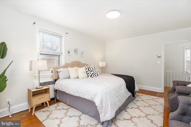 841 E Belvedere Ave E, Baltimore, MD 21212 - bedroom featuring radiator heating unit, wood finished floors, and baseboards