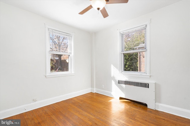 841 E Belvedere Ave E, Baltimore, MD 21212 - empty room with radiator, baseboards, hardwood / wood-style flooring, and ceiling fan